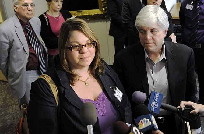 Jessica Port, front left, and her attorney Michele Zavos, front right, speak to reporters after the Court of Appeals of Maryland heard her case for divorce from her wife, Virginia Anne Cowan, back right, Friday, April 6, 2012, in Annapolis, Md. The couple married in California but were denied a divorce in Maryland.