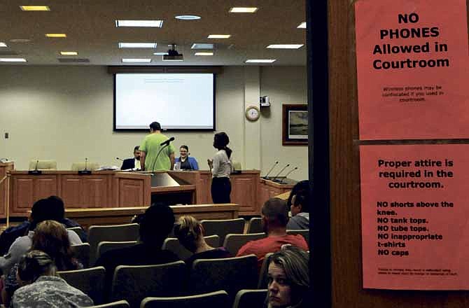 Signs outlining proper courtroom dress and decorum greet those who attend Municipal Court held in the Jefferson City Council chambers.