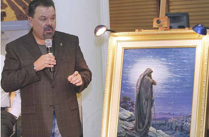In this Sept. 15, 2006 file photo, artist Thomas Kinkade unveils his painting, "Prayer For Peace," at the opening of the exhibit "From Abraham to Jesus," in Atlanta. Kinkade, whose brushwork paintings of idyllic landscapes, cottages and churches have been big sellers for dealers across the United States, died Friday, April 6, 2012, a family spokesman said. He was 54. 
