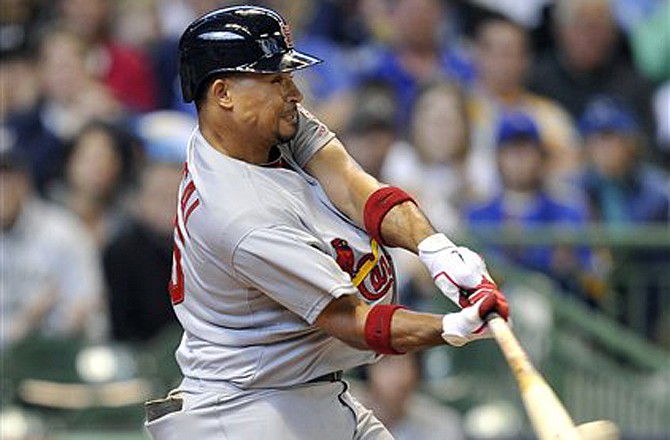 Cardinals shortstop Rafael Furcal singles to score a run during the fourth inning of Sunday's game against the Brewers in Milwaukee.