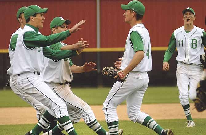 Blair Oaks players rush the infield to mob pitcher Tanner Kemna after he struck out the last Eureka batter to seal the Falcons' championship victory Saturday at the Capital City Baseball Invitational at Vivion Field.