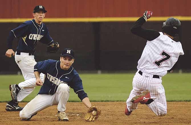 Helias second baseman Logan Gaines gets set to put the tag on Jefferson City's Dylan Brauner as he attempts to steal second base during Saturday's Capital City Invitational seventh-place game at Vivion Field.