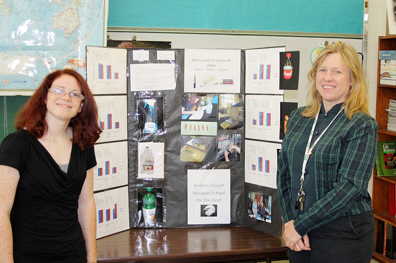 MSD sophomore Andrea Crouch, left, poses with her winning science project and her teacher, Susan Peterson. Crouch placed second in RIT's annual science fair for deaf and hard of hearing students.