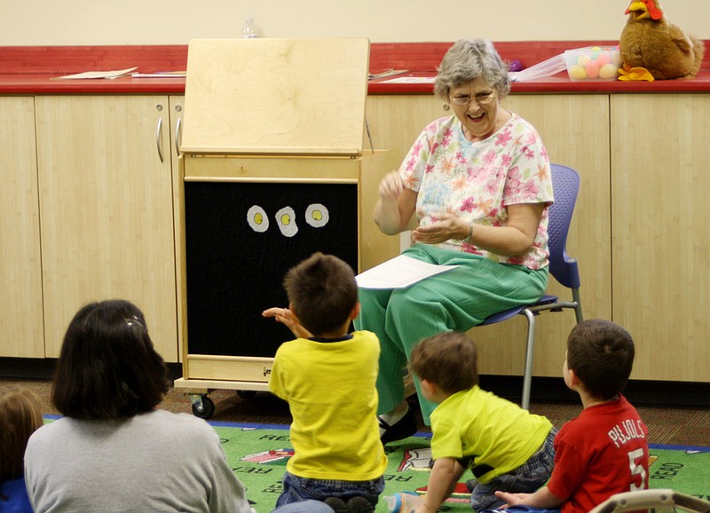 Children's librarian Janice Miller reads a story about cooking breakfast to preschoolers Tuesday morning. Eggs were the common theme in the books, stories, activities and crafts she planned for this week's Family Story Time.