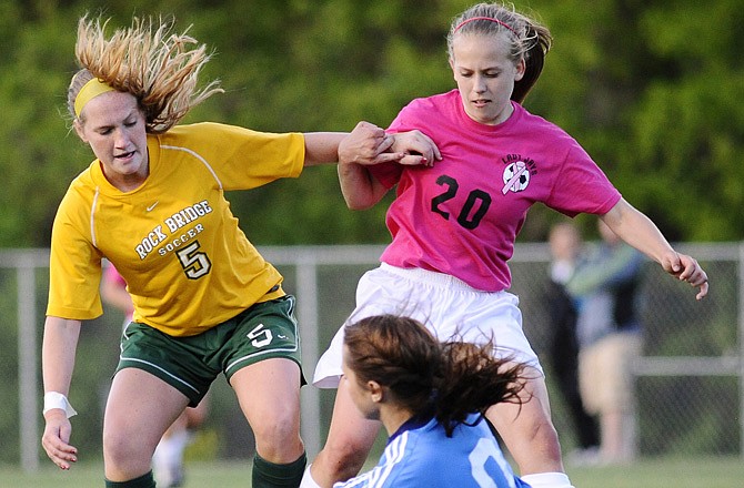 Jefferson City's Brianna Lock (20) and Rock Bridge's Katrina Fox fight for the ball as Bruins goalkeeper Madison Boyken smothers it during the first half of Tuesday's game at the 179 Soccer Park.