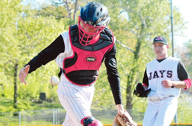 Jays catcher Sam Atkinson flips the ball from his glove to his throwing hand after fielding a bunt during Wednesday's game against Waynesville at Vivion Field.