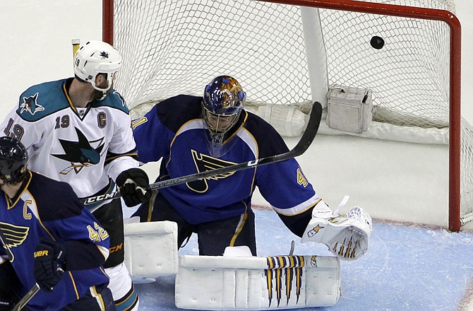 The Sharks' Joe Thornton (19) watches as a shot by teammate Martin Havlat (not shown) gets past Blues goalie Jaroslav Halak during the second period of Game 1 of the Western Conference Quarterfinals on Thursday in St. Louis.