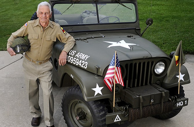 Jefferson City chiropractor Dr. Joseph Kayser stands beside his fully restored 1952 Willys M38A1 Jeep. Dr. Kayser, who serves as the president of the Midwest Willys Jeep Reunion and the Military Vehicle Preservation Association, said it took him two years to fully restore the vehicle to its past glory.