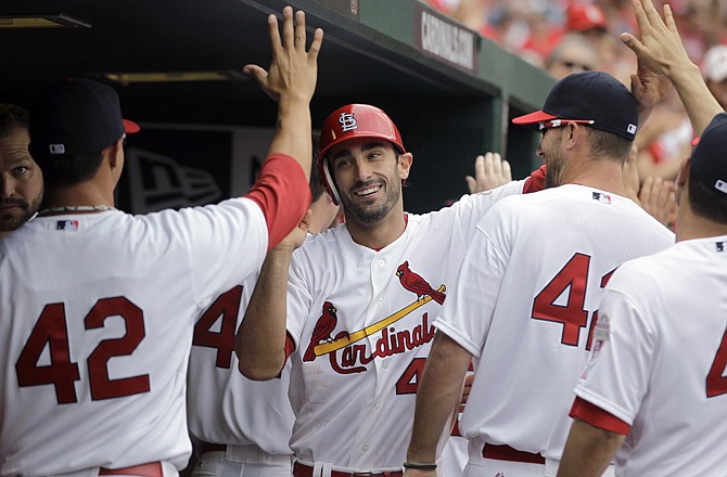 Matt Carpenter is congratulated by his Cardinal teammates after hitting a two-run home run during the fifth inning of Sunday afternoon's game against the Cubs at Busch Stadium.