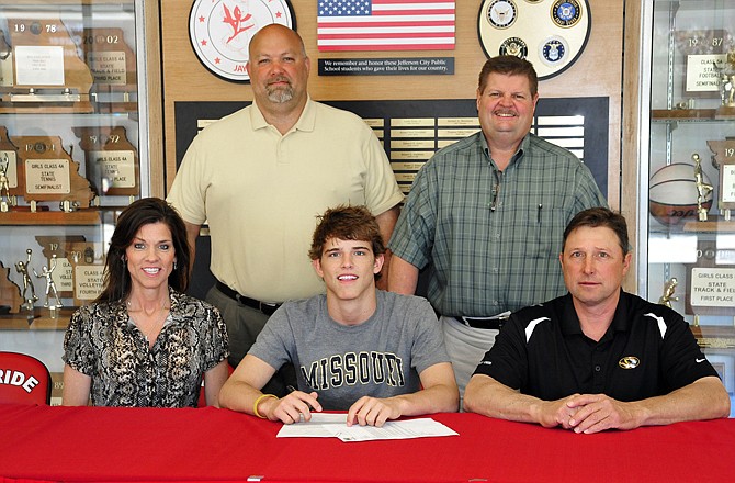 Cole Baumgartner of Jefferson City High School (seated, center) signed a wrestling scholarship with the University of Missouri on Monday at Fleming Fieldhouse. Also seated are his parents,  Kim and Danny Baumgartner. Standing (from left) are Jefferson City assistant athletic director Lou Mazzocco and Jays head wrestling coach Phil Cagle.