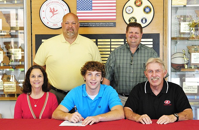 Jared Johnson of Jefferson City High School (seated, center) signs a wrestling scholarship with the University of Tennesse-Chatanooga on Monday at Fleming Fieldhouse. Also seated are his parents, Tina and Steve Johnson.Standing (from left) are Jefferson City assistant athletice director Lou Mazzocco and Jays head  coach Phil Cagle.