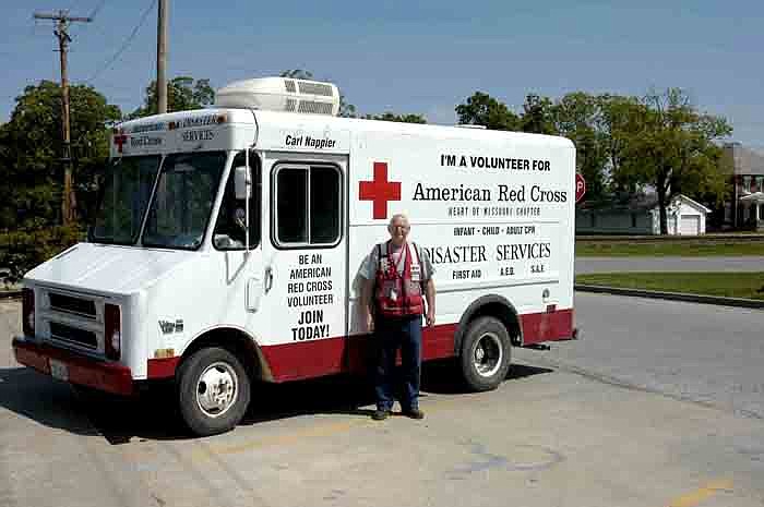 Red Cross volunteer Carl Nappier with his personal Red Cross marked vehicle. Inside he has maps and photos from many of disasters he has responded to in the last four years. 