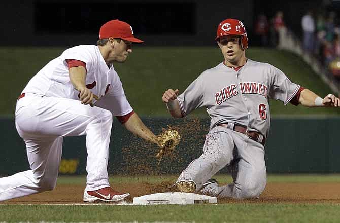Cincinnati Reds' Drew Stubbs, right, is tagged out by St. Louis Cardinals third baseman David Freese during the third inning of a baseball game Tuesday, April 17, 2012, in St. Louis. 