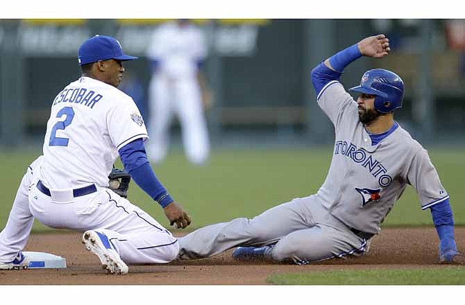Toronto Blue Jays' Jose Bautista, right, beats the tag by Kansas City Royals' Alcides Escobar to steal second during the first inning of a baseball game on Friday, April 20, 2012, in Kansas City, Mo.