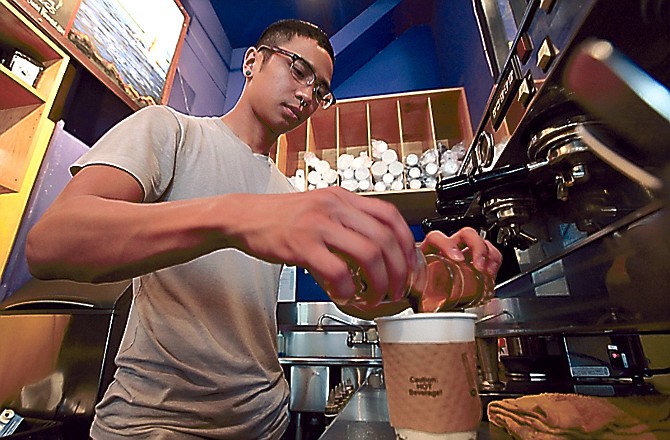 Barista Michael Bledsoe prepares a two-shot coffee drink in a coffee shop in Seattle. The 2010 graduate holds a degree in creative writing, but is barely making minimum wage.