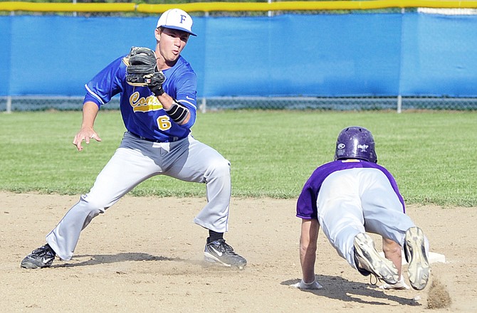 Fatima's Patrick Schnieders prepares to tag a Hickman player attempting to steal second base during the Kewpies 15-6 win against Fatima on Monday in Westphalia.