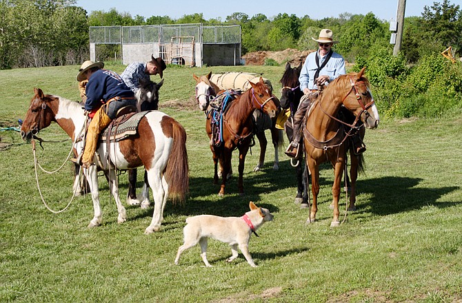 Clockwise from left are Lynn Tuggle, Evan Brendel, Tim Tuggle and Chico the dog as they prepare for their journey. Brendel, New Bloomfield, befriended the traveling missionaries and will join them for a week of their ride to North Carolina.