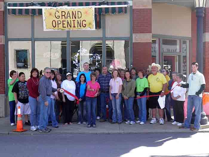 Members of the California Area Chamber of Commerce, family and friends help Tiffany's Hair, Nails and Tanning Owner Tiffany Roll cut the ribbon on her new business.