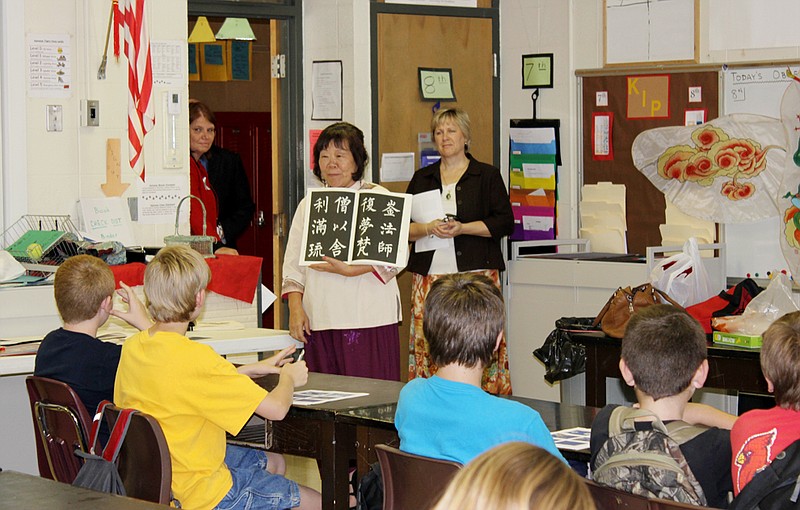Hsiao-Mei Wiedmeyer, with the MU Confucius Institute program, talks to Auxvasse Elementary students about Chinese language during an after-school program. The Confucius Institute will provide edcuational cultural outreach programs for the North Callaway School District.