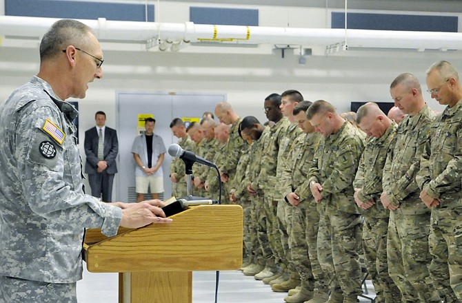 Chaplain Gary Gilmore leads the Agricultural Development Team V (ADT V) in prayer prior to their dismissal Wednesday afternoon as they were officially welcomed home after their 14-month deployment to Nangarhar Province, Afghanistan.