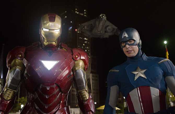 In this film image released by Disney, Iron Man, portrayed by Robert Downey Jr., left, and Captain America, portrayed by Chris Evans, are shown in a scene from "The Avengers" 