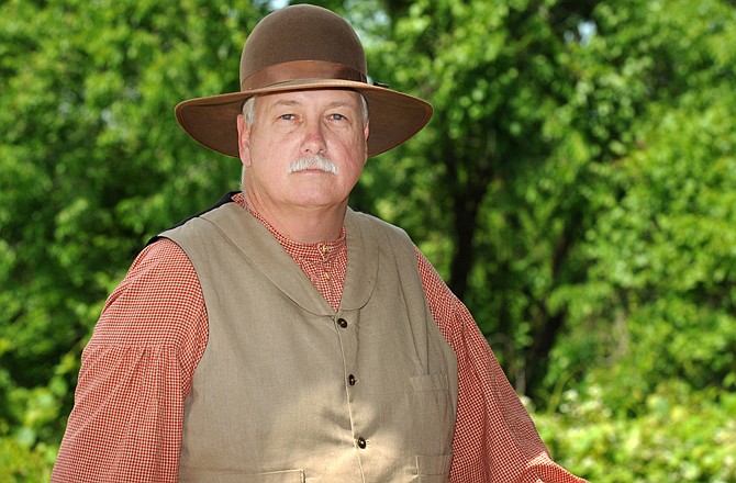 Jim Hickman poses for a photograph wearing some of his Civil War re-enactor clothing.