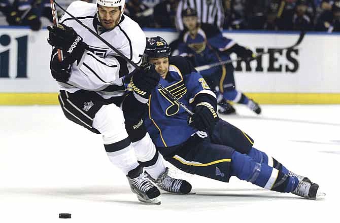 Los Angeles Kings' Dwight King, left, and St. Louis Blues' Chris Stewart chase after a loose puck during the third period of Game 1 in a second-round NHL Stanley Cup hockey playoff series, Saturday, April 28, 2012, in St. Louis. The Kings won 3-1.