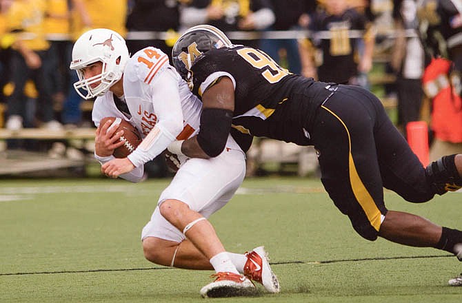 Former Missouri defensive end Terrell Resonno sacks Texas quarterback David Ash during a game last season. Resonno, a former Jefferson City Jay, signed a free-agent deal with the Minnesota Vikings. 