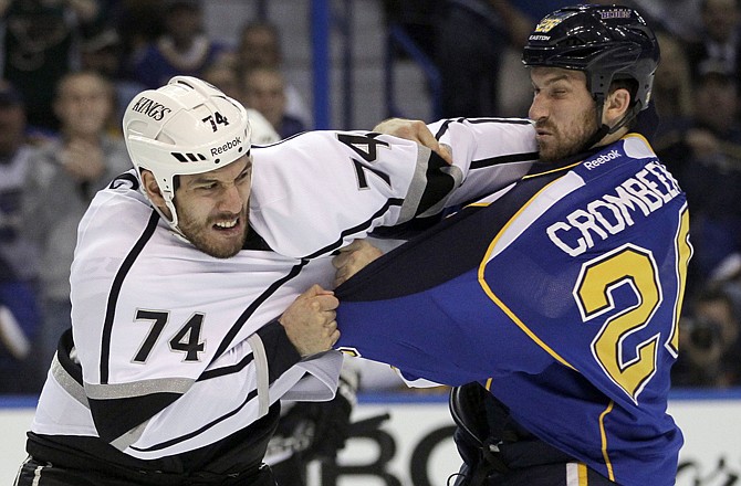 Los Angeles Kings' Dwight King, left, and St. Louis Blues' B.J. Crombeen fight during the first period in Game 2 Monday in St. Louis.