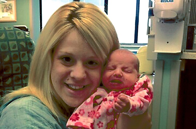 Aileen Dannelley holds her baby, Savannah, at Advocate Christ Medical Center in Oak Lawn, Ill. The month-old baby is being treated with methadone for withdrawal while she and her mother both fight addiction to prescription painkillers.