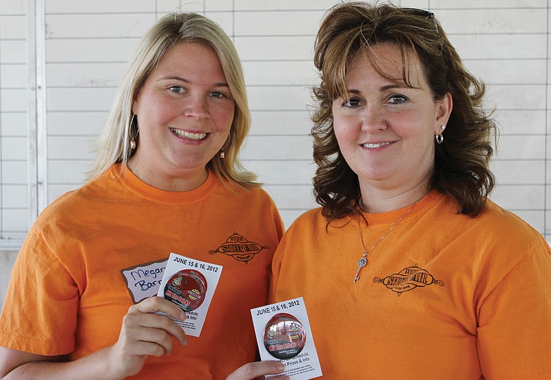 Megan Barnes, left, chairman of the Fulton Street Fair, and Ronda Miller, chairman of button sales, kicked off sales of the buttons Tuesday evening at the Chamber's After Hours event at Tanglewood Golf Course.