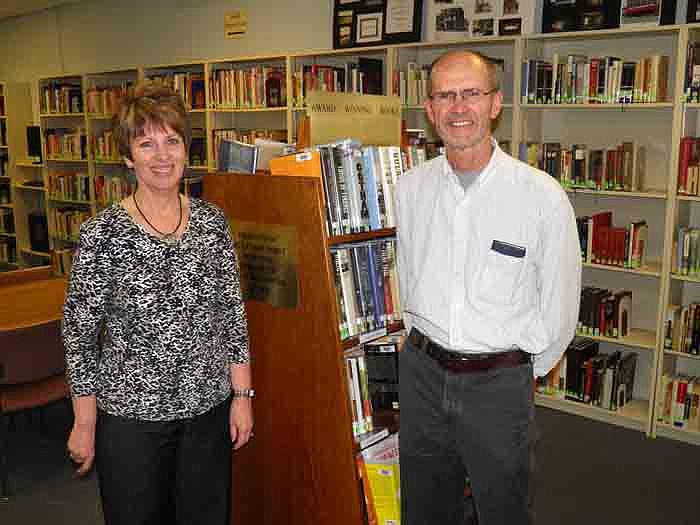 Wood Place Public Library, California, Director Connie Walker, left, with Ken Latham, right, who has created and funded a collection of award winning books for the library to honor the Latham family legacy.