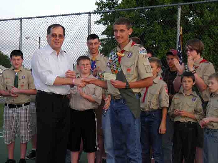 Dr. Peter Kurowski, president of the California Kiwanis, presents Boy Scouts Troop 120 Senior Patrol Leader Trevor Barbour with a check of $445.56, half the money raised from the Kiwanis Pancake and Sausage Breakfast which the Boys Scouts helped with at the Court of Honor Ceremony held Monday, April 30, at City Park.