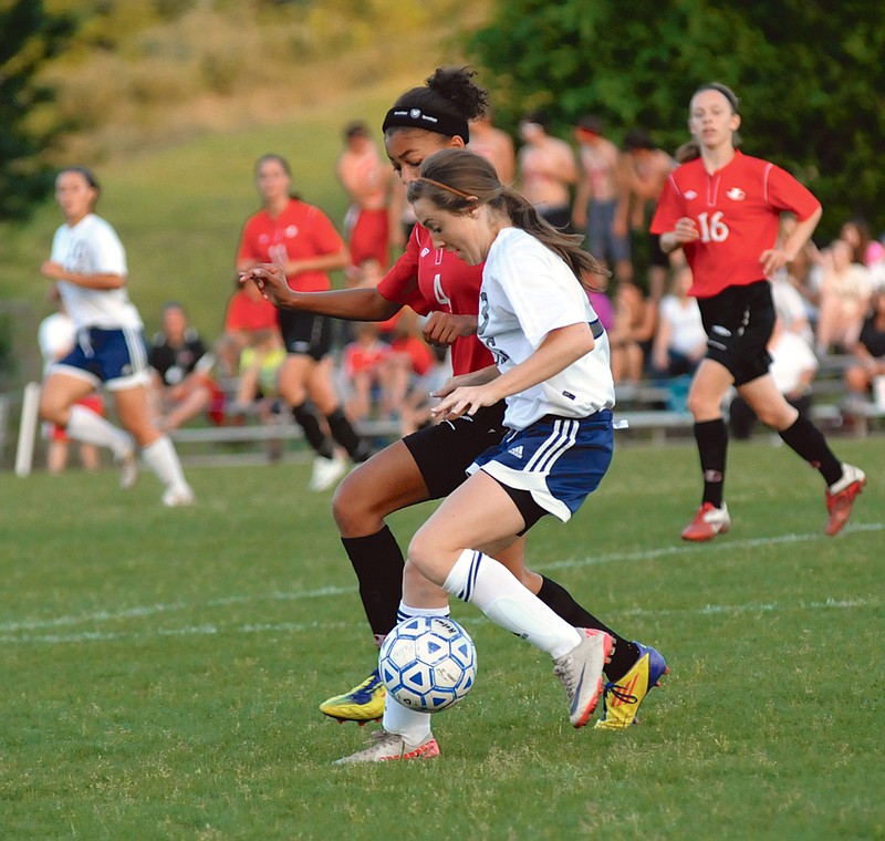 Jordan Poire of Helias (front) and Jefferson City's Eden Hoogveld battle for possession of the ball during Wednesday's game at 179 Soccer Park. Helias won 2-0.