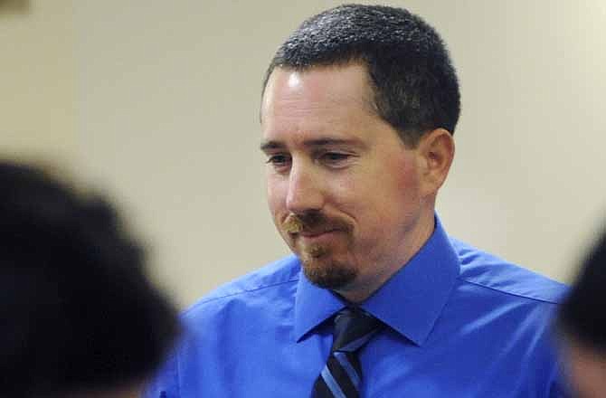 In this June 2, 2011, file photo Mark Woodworth returns to court after a recess during a special hearing in Columbia, Mo. The Chillicothe, Mo., man twice convicted in the 1990 slaying of a Missouri farm wife was victim of "a manifest injustice" and should have his conviction set aside, a judge ruled Tuesday, May 1, 2012.