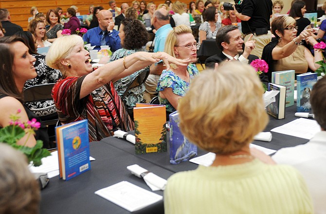 Audience members point to someone at their table who they think looks like actor Steve Carell for a contest during the Jefferson City Teacher Appreciation Banquet on Thursday evening in the Lewis and Clark Middle School gym.