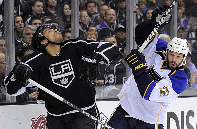 Kings center Jordan Nolan, left, reacts after he was hit on the face by the stick of Blues center Scott Nichol during the third period Sunday in Los Angeles.