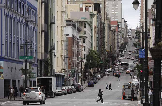 This Feb. 15, 2011 file photo shows a view looking up Taylor Street from Market Street in San Francisco. With Twitter's new headquarters set to open there soon, residents of a San Francisco neighborhood notorious for crime, drugs and homelessness remain among the least likely to have any way to send a tweet, much less access to basic goods and services. 
