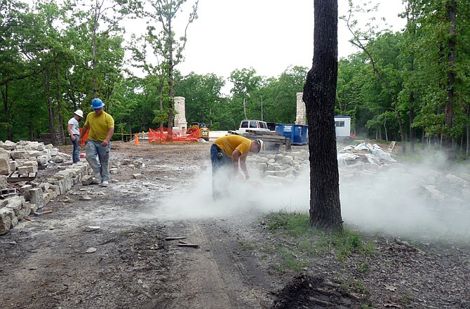 State Fair Community College students assemble a bench by using stones salvaged from the original Camp Pin Oak Lodge dining hall that burned in September 2010.