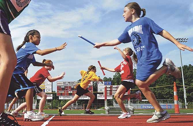 
A Lawson Elementary runner sprints out to the lead in the far lane during a heat in the 4th grade girls' 240-yard relay at the 63rd Annual Little Olympics at Adkins Stadium in Jefferson City on Saturday.