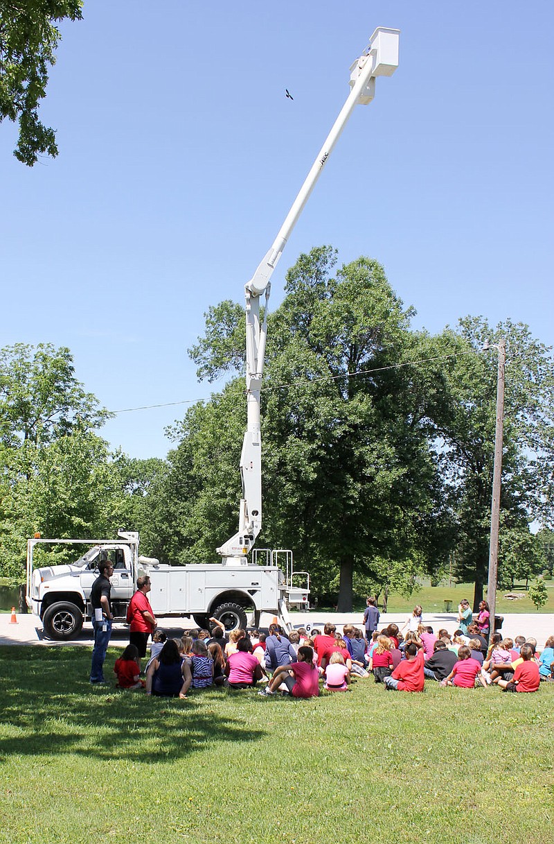 City workers show off the long reach of a cherrypicker for McIntire Elementary students for their Careers on Wheels day Tuesday.