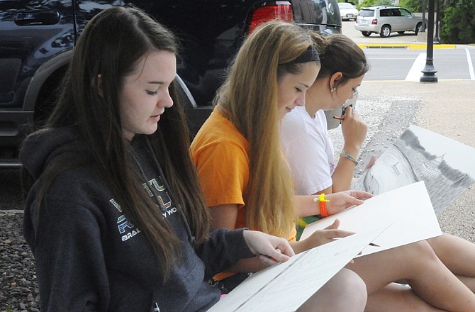 Liz Veit, left, Alex Trower, center, and Nicole Ott, all sophomores at Helias High School, work on their sketches during Sketch Day.