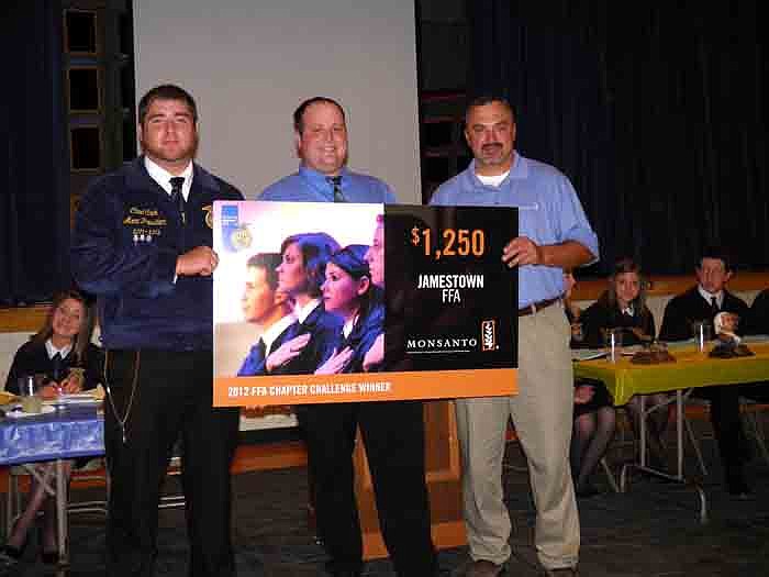 Placing fifth in the state for the Monsanto FFA Chapter Challenge, the Jamestown FFA was presented $1,250 in credit at the FFA Store. Receiving the award from Monsanto Technology Development Representative Jody Gander, from left, is Chapter President Chad Cook, Advisor John Muri and Gander.