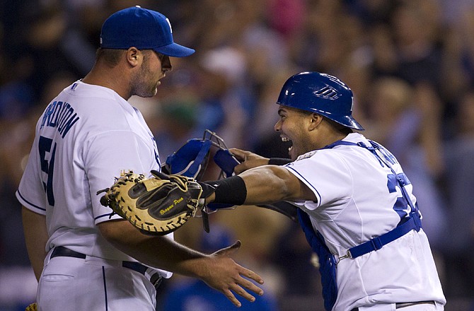 Royals catcher Brayan Pena (right) runs to hug relief pitcher Jonathan Broxton following Wednesday's 4-3 win against the Red Sox in Kansas City.