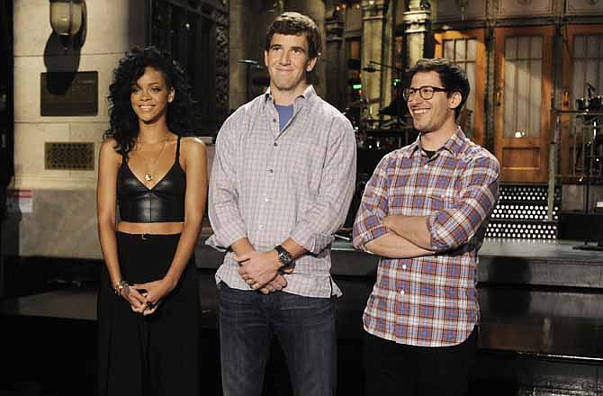 In this May 3, 2012 photo, New York Giants quarterback Eli Manning, center, stands with "Saturday Night Live" cast member Andy Samberg, right, and singer Rihanna during a taping of promos for the May 5 broadcast of "Saturday Night Live.". (AP Photo/NBC, Dana Edelson)