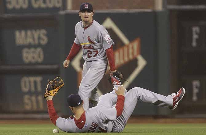 St. Louis Cardinals first baseman Allen Craig, bottom, cannot catch a base hit by San Francisco Giants pitcher Madison Bumgarner as second baseman Tyler Greene (27) looks on during the seventh inning of a baseball game in San Francisco, Wednesday, May 16, 2012.
