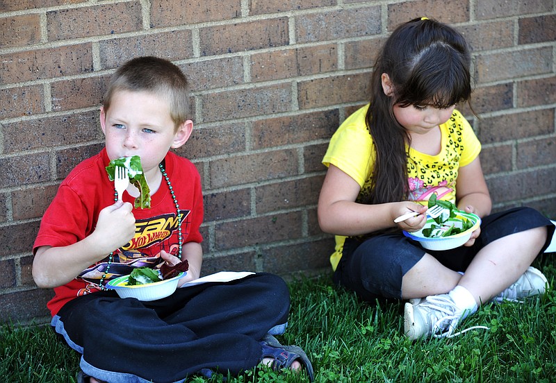 Kindergarten students Kane Bonvillain, left, and Kaydence Turnbow, of Callaway Hills School were able to sample the spinach and lettuce they grew this semester and had a spinach party Thursday afternoon. 