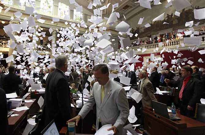 Members of the Missouri House of Representatives throw their papers in the air at the conclusion of the final day of the legislative session Friday, May 18, 2012, in Jefferson City, Mo. 
