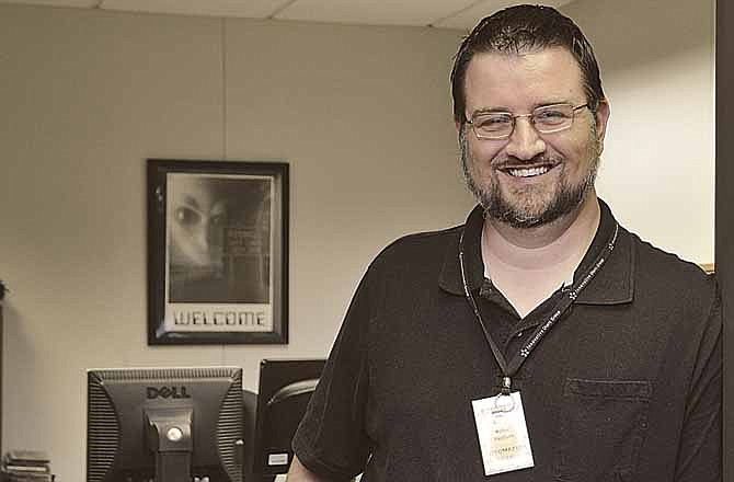 Mike Washburn is responsible for the technology that makes it possible for patrons to check out books at Missouri River Regional Library in Jefferson City.