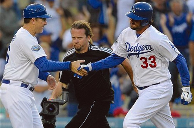 Dodgers outfielder Scott Van Slyke (33) celebrates his two-run homer with third base coach Tim Wallach as he rounds the the bases during Sunday's game against the Cardinals.